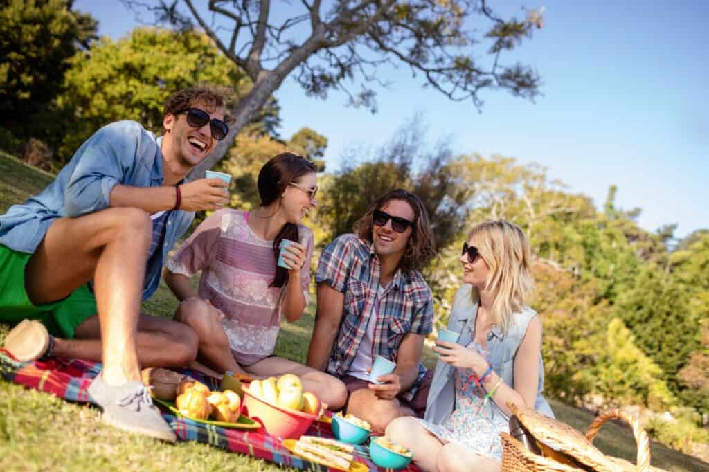 A group of friends having a picnic at the park