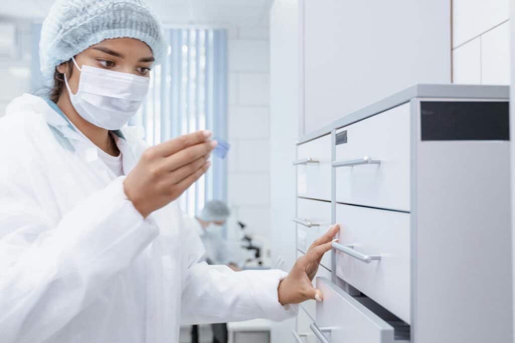 Medical staff in front of a filing cabinet