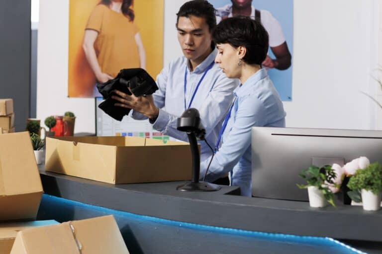 The front desk surrounded by moving boxes and crew packing office items in the concept of 'What Are Office Removals Services'.