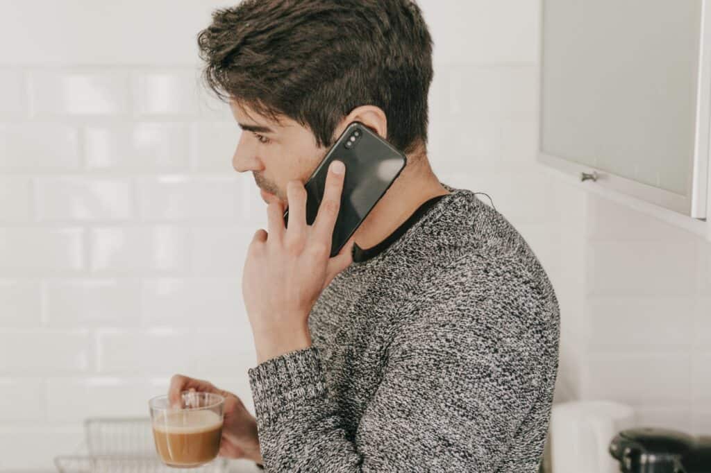 A young man speaking with a potential new utility provider after moving in