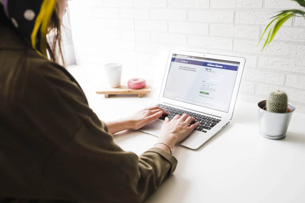 A female employee in front of the laptop to update the company's social media of the office move