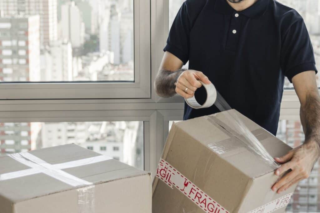 Cropped image of a professional mover packing in the office in the concept of 'Benefits of Hiring a Professional Office Removal Service'.