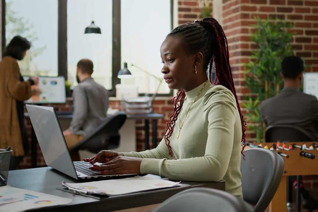 A female employee sends an email to business partners about the move