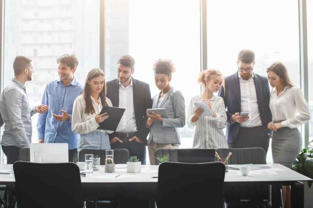 Clients and partners standing in the conference room after the office move meeting